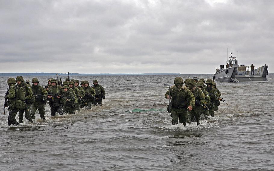Estonian troops move ashore during amphibious assault training. 