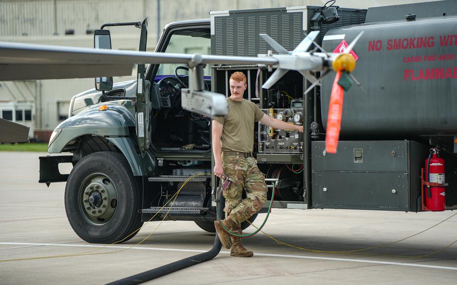 A man stands next to a truck.