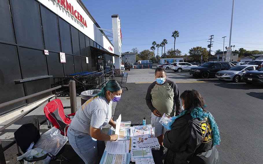 Community health workers distribute COVID-19 related resources at a supermarket in Los Angeles. 