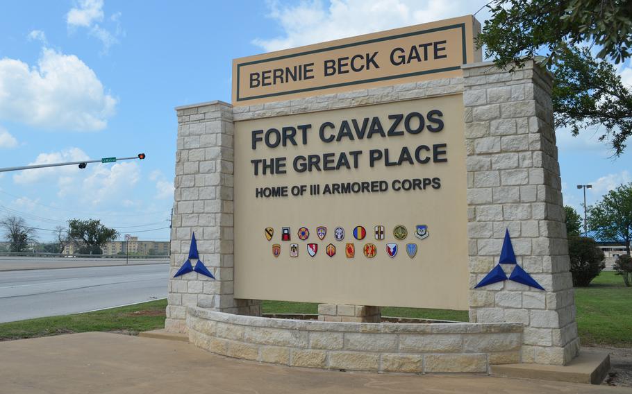 A welcome sign stands next to the road approaching the entrance to Fort Cavazos.