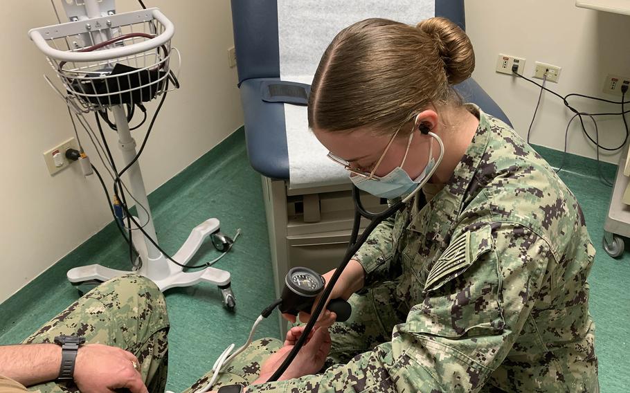 Seaman Apprentice Krista Fitch takes the blood pressure of a sailor at the active-duty medical clinic at Naval Support Activity Naples in Italy on April 20, 2023. A program at the base seeks to improve service members' health with a focus on guiding those whose blood pressure could be a precursor to major medical issues.