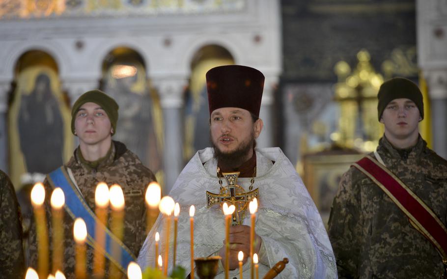 Father Bohdan Vayda, a priest at St. Volodymyr’s Cathedral in Kyiv, Ukraine, speaks at a funeral for a soldier on Nov. 1, 2022. The soldier, Gurgen Gagnidze, had left his home in the nation of Georgia to fight Russian forces in Ukraine. Gagnidze, 40, died in late October in an ambush in east Ukraine. 