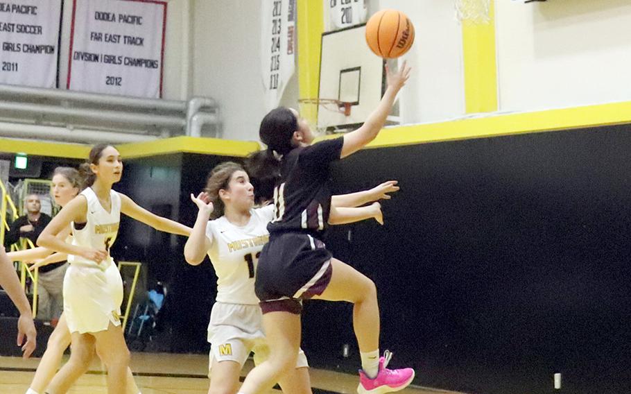 Zama's Lindsey So drives to the basket against American School In Japan's Gigi Isenberg during Wednesday's Kanto Plain girls basketball game. The Mustangs won 38-32.