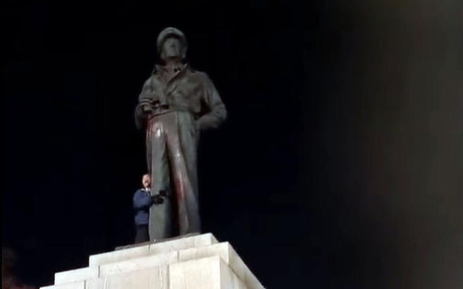 A man stands alongside the defaced statue of Gen. Douglas MacArthur at Freedom Park in Incheon, South Korea, Thursday, April 28, 2021. The image is from a video posted to Facebook by Peace Agreement Movement Headquarters, an anti-U.S. military group.