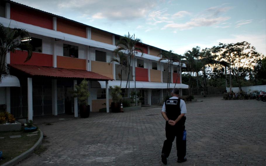 A security guard patrols Primo Bitti, the state school in Aracruz where the 16-year-old former student shot three people to death and wounded eight more. 