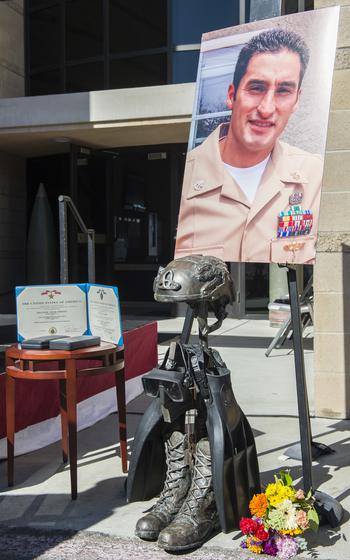 A memorial honors Chief Petty Officer Jason Finan at Naval Amphibious Base Coronado, Calif. Finan was killed in action Oct. 20, 2016, while deployed to Iraq. His family is now a plaintiff in a lawsuit arguing that French cement firm Lafarge helped fund the Islamic State group's deadly terror attacks that led to Finan's death. 