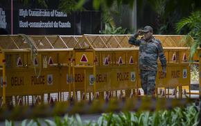 An Indian paramilitary soldier stands guard next to a police barricade outside the Canadian High Commission in New Delhi, India, Tuesday, Sept. 19, 2023. Tensions between India and Canada are high after Prime Minister Justin Trudeau's government expelled a top Indian diplomat and accused India of having links to the assassination in Canada of Sikh leader Hardeep Singh Nijjar, a strong supporter of an independent Sikh homeland. (AP Photo/Altaf Qadri)
