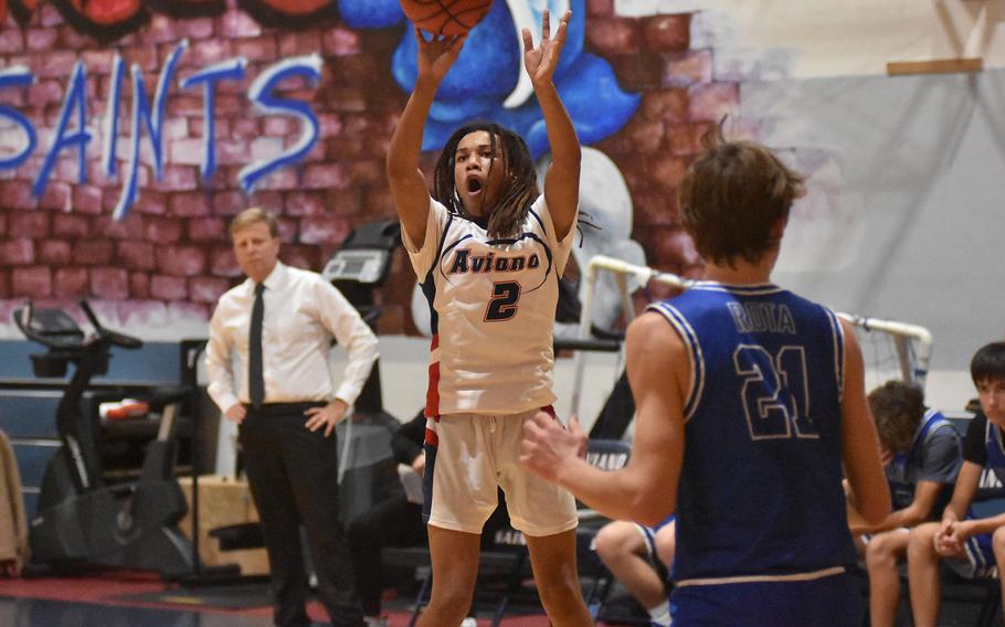 Rota's Tyler DeMeritt had four blocks on Friday, Dec. 9, 2022, but couldn't get to this shot by Aviano's Andrew Walker in the Saints' 51-40 victory over the Admirals in Aviano, Italy. Rota coach Ben Anderson, watching the play, saw his team's 25-game winning streak snapped.