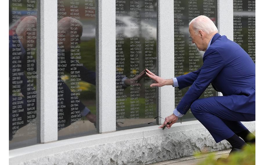 President Joe Biden visits a War Memorial in Scranton, Pa., on April 17, 2024, and touches the wall near his uncle's name, Ambrose J Finnegan Jr., who died in WWII. 