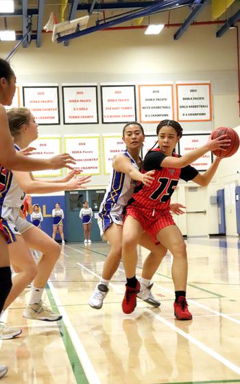 Nile C. Kinnick's Imani Mincey looks for a teammate inside while Yokota's Alicia Tanoue defends in a game Friday, Jan. 6, 2023.