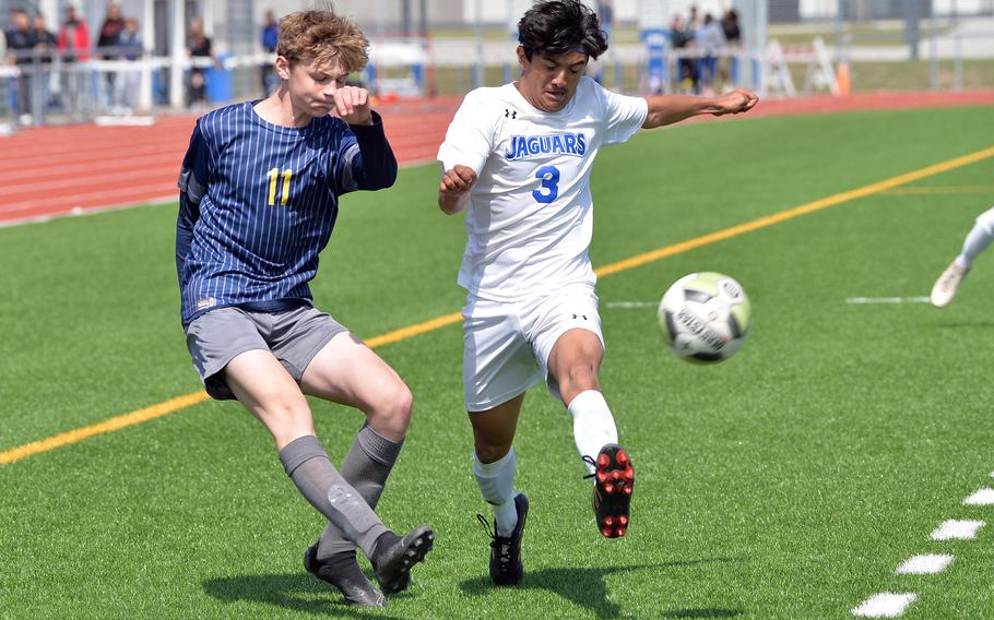 Ansbach’s Benjamin Schuck sends a cross against Sigonella’s Alessandro Montero in the Division III boys final at the DODEA-Europe soccer championships in Ramstein, Germany, May 18, 2023. Sigonella won 4-1.