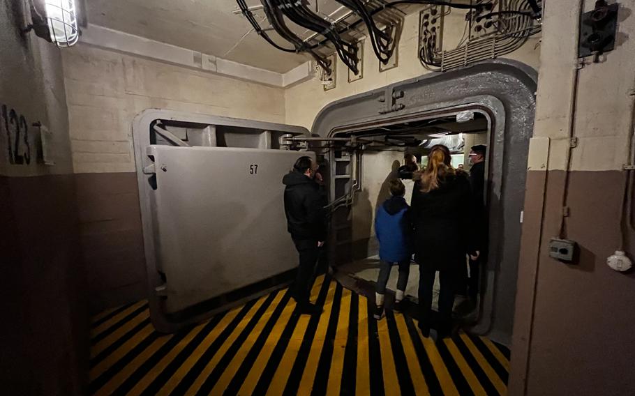 Visitors enter through one of several secondary nuclear blast doors at the former German government bunker in Bad Neuenahr-Ahrweiler, Germany, Feb. 13, 2022. The facility was designed to house 3,000 personnel for 30 days.