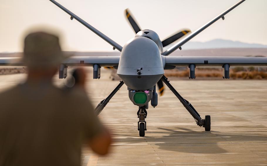 A crew chief assigned to the 163rd Attack Wing marshals an MQ-9 Reaper at Marine Corps Air Ground Combat Center Twentynine Palms, Calif, July 21, 2022. 