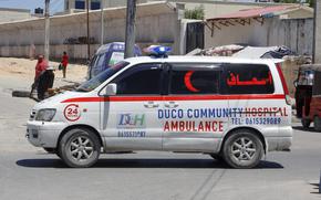 An ambulance is parked nearby the attack site.