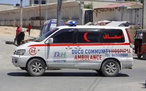 An ambulance is parked nearby the attack site.