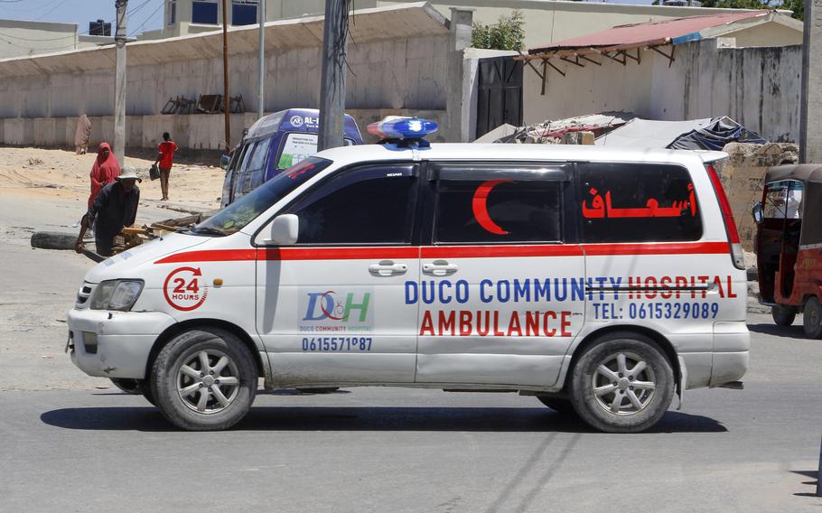 An ambulance is parked nearby the attack site.