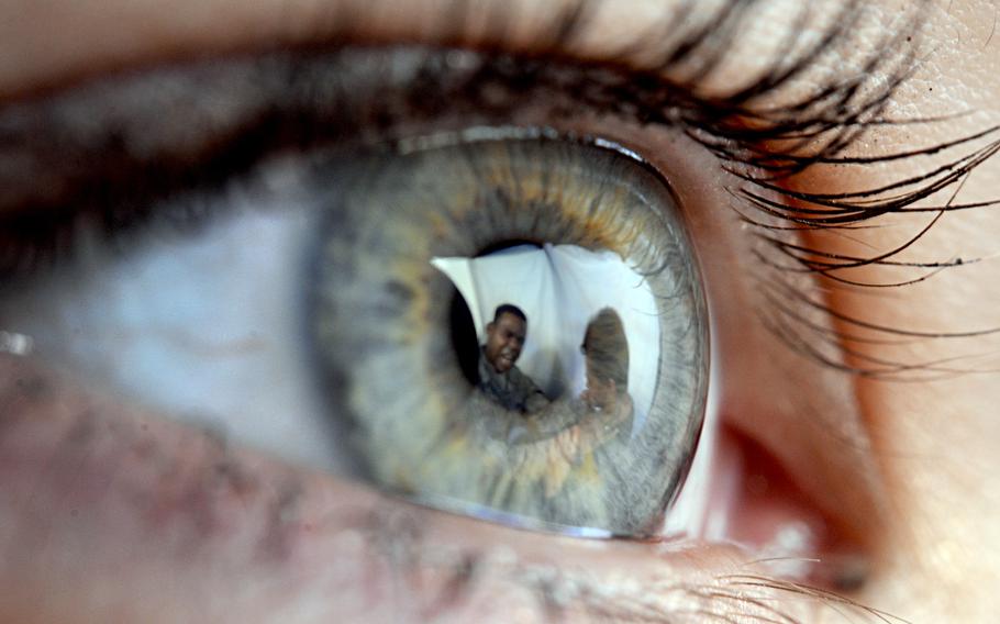 A woman watches a domestic violence incident in this photo illustration released by the Air Force in 2016. 