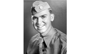A black-and-white, World War II-era portrait of an Army soldier posing in dress uniform.
