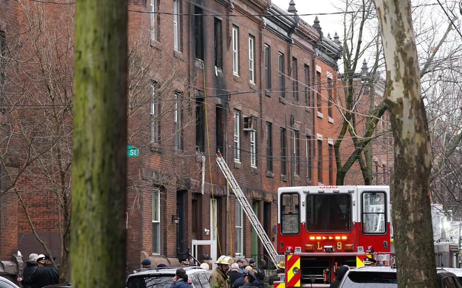 Philadelphia firefighters work at the scene of a deadly row house fire, Wednesday, Jan. 5, 2022, in the Fairmount neighborhood of Philadelphia.