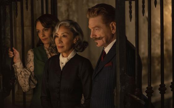 From left, Tina Fey as Ariadne Oliver, Michelle Yeoh as Mrs. Reynolds and Kenneth Branagh as Hercule Poirot in a scene from “A Haunting in Venice.”  