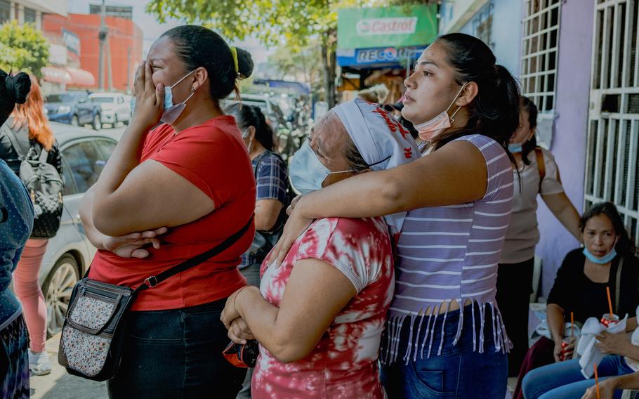 Flor de Maria Erazo, 49, cries over seeing her son at the detention center. 