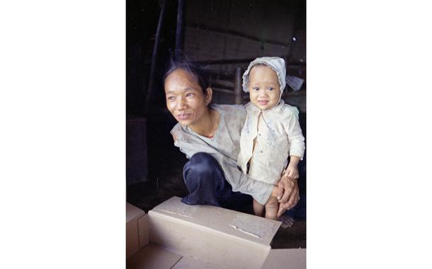 Dien Ban, South Vietnam, Nov. 25, 1968: A Vietnamese toddler stares into the camera and stands on his wobbly feet supported by a Vietnamese middle-aged woman. American Marines and South Vietnamese troops 7,000 strong are conducting a cordon and search operation in the area, Stars and Stripes reported at the time. The operation - which started November 20th and would end December 9th, 1968 -  systematically tightened a 15-mile circle in the "Dodge City" area south of Da Nang where between 200 and 900 VC and NVA were holed up in caves and dugouts. The nickname "Dodge City" was given due to frequent ambushes, firefights and rocket attacks on U.S. troops. Apart from eliminating those threats, one of the cordon's other objectives was to kill or capture the estimated 150 Communist administrators [politicians] operating around Dien Ban.  Vietnamese civilians found within the circle were moved to refugee camps to keep them out of the crossfire.

Looking for Stars and Stripes’ coverage of the Vietnam War? Subscribe to Stars and Stripes’ historic newspaper archive! We have digitized our 1948-1999 European and Pacific editions, as well as several of our WWII editions and made them available online through https://starsandstripes.newspaperarchive.com/

META TAGS:  Vietnam war; war; USMC; Marine Corps; Marines; 1st Marine Division; servicemember; combat; Vietnamese; child; 