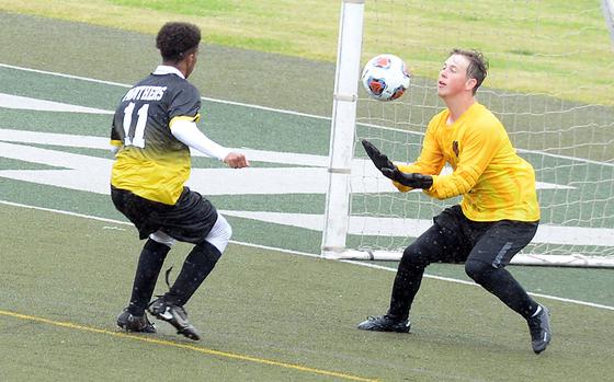 Nile C. Kinnick keeper Aiden Talbot snags the ball away from Kadena's Yoshua Whipp.