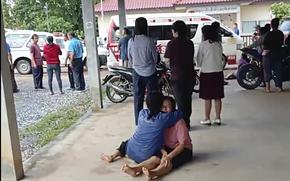 In this image taken from video, a distraught woman is comforted outside the site of an attack at a daycare center, Thursday, Oct. 6, 2022, in the town of Nongbua Lamphu, north eastern Thailand. More than 30 people, primarily children, were killed Thursday when a gunman opened fire in the childcare center authorities said. (Mungkorn Sriboonreung Rescue Group via AP)