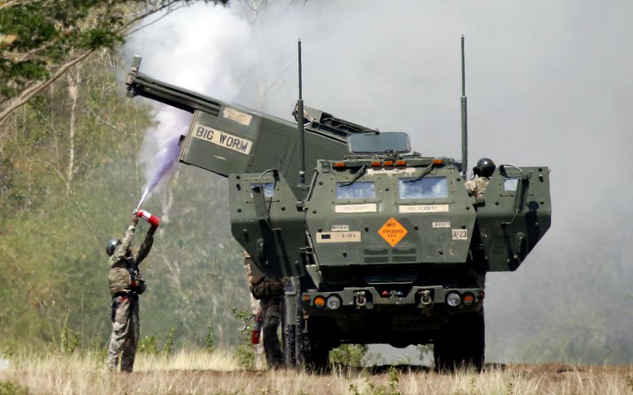A soldier cools off a U.S. Army High Mobility Artillery Rocket System, or HIMARS, during the annual Salaknib exercise at Fort Magsaysay, Philippines, Friday, March 31, 2023.