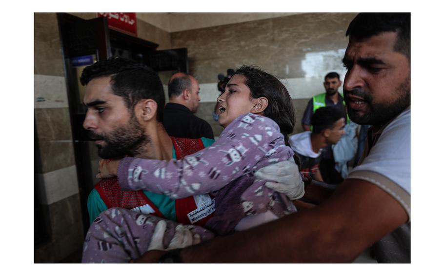 An injured girl is brought to Nasser Hospital on Thursday, Oct. 19, 2023. According to Gaza's Health Ministry, four hospitals were entirely out of service because they were directly hit in strikes. 