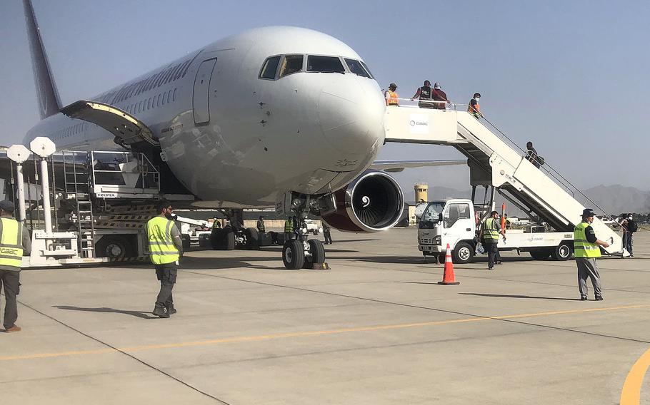 People board a plane at the airport in Kabul as they prepare to evacuate Afghanistan, Aug. 15, 2021. As the U.S. military seeks to evacuate some 5,000 people a day from Kabul, the challenge of getting out of Afghanistan is getting into the airfield that’s secured by both U.S. and Taliban forces.