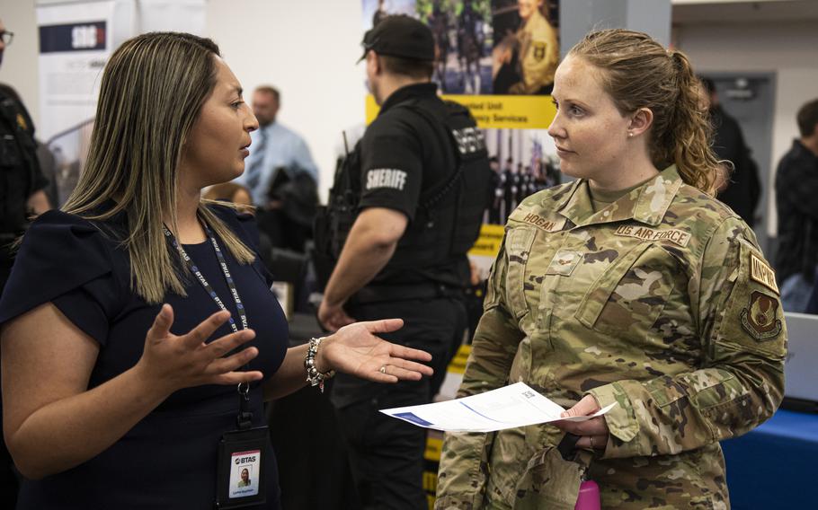 Leslee Guzman, BTS talent acquisitions, gives Senior Airman Ashley Hogan, 88th Force Support Squadron manpower analyst, information about career opportunities during the Hiring Our Heroes Job Fair April 27, 2023, at the Hope Hotel & Richard C. Holbrooke Conference Center, Wright-Patterson Air Force Base, Ohio. The U.S. Chamber of Commerce Foundation’s annual hiring event helps transitioning service members, veterans and military spouses find employment.