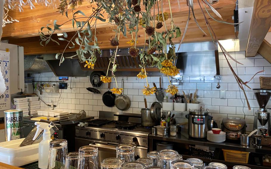 Dried flowers hang near the kitchen at the Pork Shop, one of many restaurants dotting Johnson Town, a former U.S. military housing area north of Tokyo. 