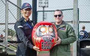 The skippers of the JS Izumo and USS Ronald Reagan, Capt. Jo Takemasa and Capt. Daryle Cardone, pose with a Daruma doll during a ship gift exchange in Yokosuka, Japan, April 2, 2024. 