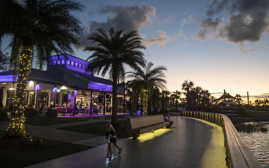 Lights illuminate Babcock Ranch’s town center at dusk. Power was back in much of Southwest Florida less than a week after Hurricane Ian made landfall. 