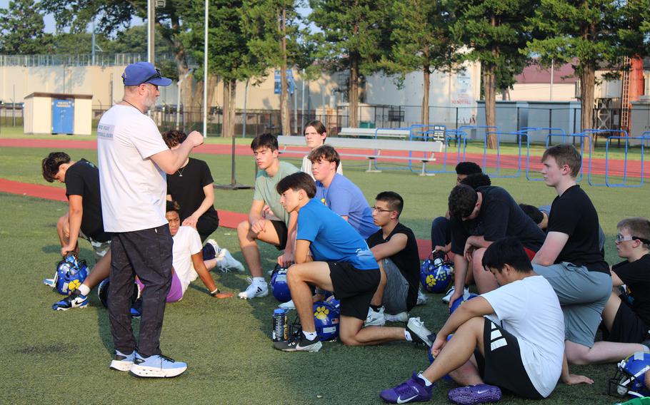 Michael Woodworth talks to his players.