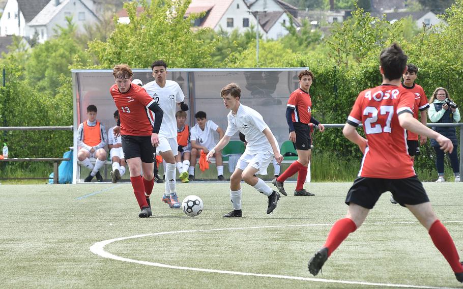 American Overseas School of Rome midfielder Seamus Burges-Sims, left, passes the ball to teammate Giorgi Antelava, right, during a Division II semifinal against Vicenza at the DODEA European soccer championships on May 17, 2023, at VfR Baumholder's stadium in Baumholder, Germany.