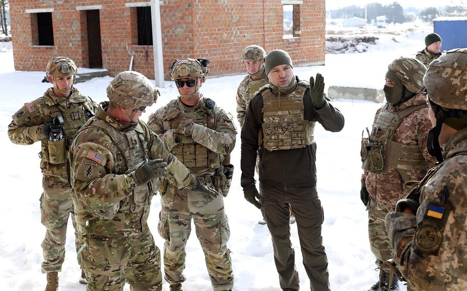 Sgt. 1st Class Jason Haigh, from Task Force Gator, 53rd Infantry Brigade Combat Team, Florida Army National Guard, second from left, provides an example while advising on teaching tactics with Ukrainian soldiers at a training center in  Yavoriv, Ukraine, Feb. 3, 2022. The unit is now training Ukrainians at Grafenwoehr, Germany. 