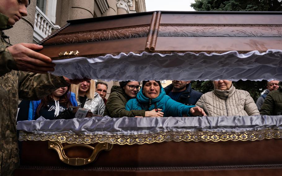 Relatives of Ivan Lipskiy grieve at his casket during a service in Odessa on March 29, 2022, for Ukrainian soldiers. Lipskiy died on March 18 during a Russian airstrike that killed more than 40 Ukrainian soldiers in the city of Mykolaiv. 