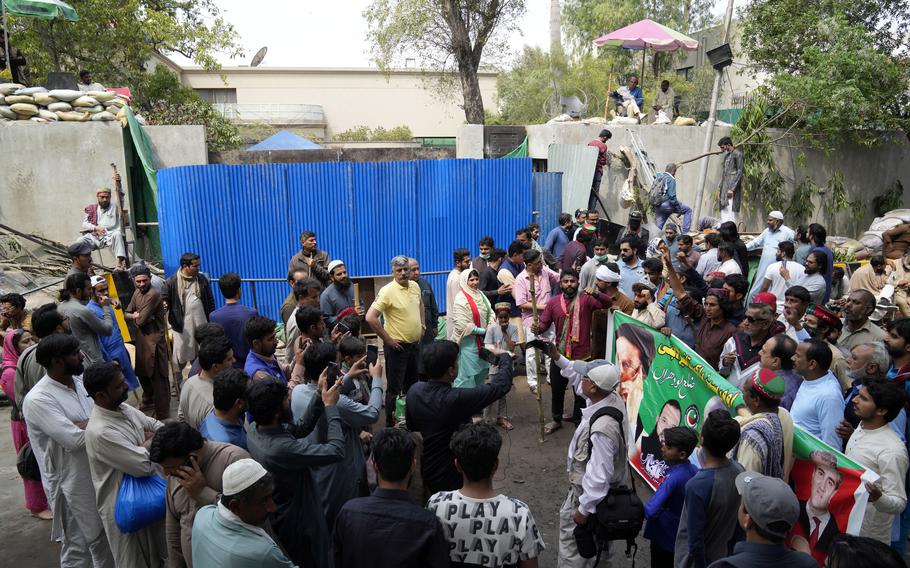 Supporters of former Prime Minister Imran Khan gather outside of the Khan house in Lahore, Pakistan, Sunday, March 19, 2023. Police in the Pakistani capital filed charges Sunday against Khan and 17 of his aides and scores of supporters, accusing them of terrorism and several other offenses after the ousted premier’s followers clashed with security forces in Islamabad the previous day.