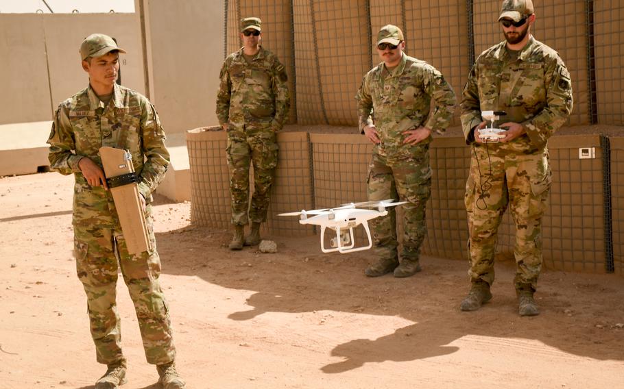 Staff Sgt. Harrison Hayes, right, lands a drone that had been jammed by Airman 1st Class Phillip Valdez, left, during training at Prince Sultan Air Base in Saudi Arabia on June 9, 2023.