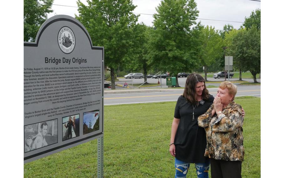 Burton Ervin’s wife, Mildred, along with Executive Director of The Fayette County Chamber of Commerce Becky Sullivan, sees for the first time the sign honoring her husband during a ceremony on July 16, 2022. Ervin Burton, who is credited as the first person to parachute from the New River Gorge Bridge 876 feet into the canyon below on Aug. 17, 1979, died in 2017.