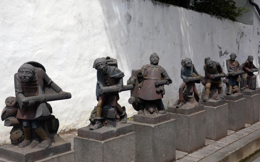 Statues on a street in Mayen, Germany, depict the “Seven Swabians” of brothers Grimm fairy tale fame. Other fairy tale-themed statues once stood in the vicinity but were moved to a less accessible area.