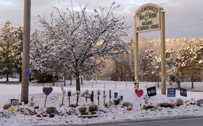 FILE - Snow accumulates outside a restaurant at a makeshift memorial for the victims of last month's mass shooting in Lewiston, Maine, Tuesday, Dec. 5, 2023.  The four members of Maine's congressional delegation are calling for an Army investigation into the events leading up to a mass shooting in the state in the wake of meeting with families affected by the killings. (AP Photo/Robert F. Bukaty, File)