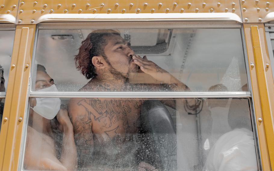 A detainee blows a kiss to relatives at El Penalito. 