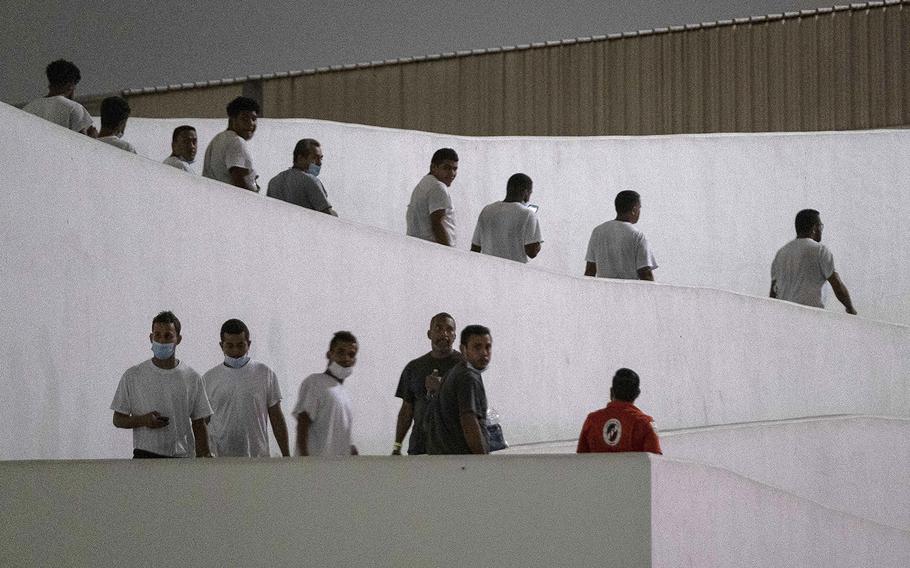 Venezuelan migrants walk after being deported by US authorities at El Chaparral crossing port of entry in Tijuana, Baja California state, Mexico, on Oct. 13, 2022. 