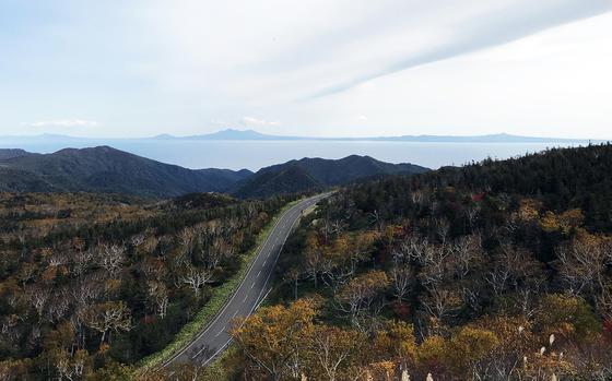 Russia-controlled Kunashiri Island is seen in the distance from the Shiretoko Peninsula on Hokkaido, Japan.