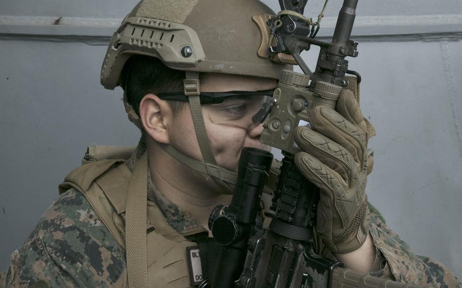 A member of the 31st Marine Expeditionary Unit serves as security aboard the USS Miguel Keith during visit, board, search and seizure training, part of the Noble Fusion exercise, in the East China Sea, Feb. 5, 2022. 