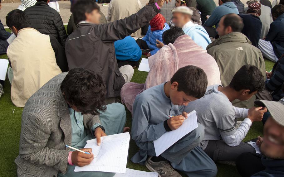 Afghan men and boys attend an English lesson at Rhine Ordnance Barracks in Kaiserslautern, Germany, Sept. 24, 2021. The Kaiserslautern Military Community is once again serving as a stopover for Afghan refugees seeking special immigrant visas so they can resettle in the U.S.
