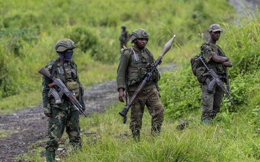 Rebels standing in eastern congo with their guns.